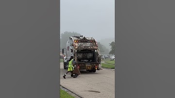 Rumpke international trash truck picking up trash rear loader