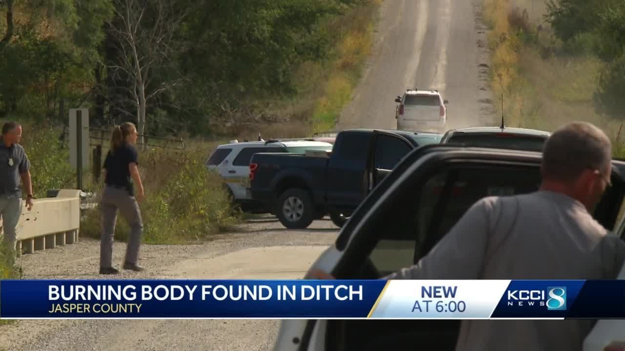 Homicide investigation underway after body found burning in ditch - YouTube