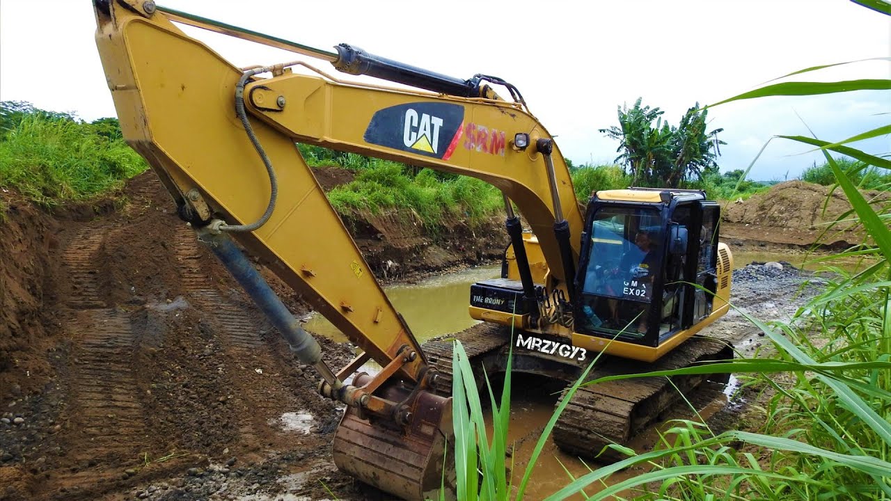 CAT 320D Excavator Digging Loading Sand And Rocks From The River Into ...
