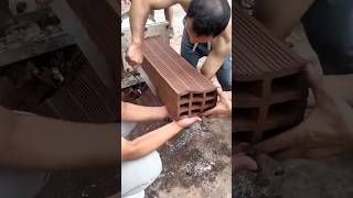 Workers Cutting Stacked Clay Bricks Using Metal Chisel Tool