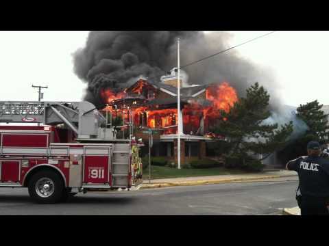 house up in flames on the beach.