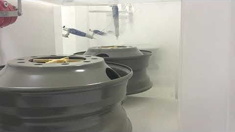 Precision Conveyor | Steel Truck Wheel Powder Coating on Chain-On-Edge Conveyor