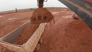 Excavator TRUCK LOADS MATERIAL WITH STONES