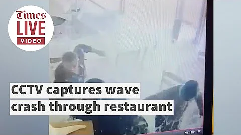 CCTV captures huge wave smash through restaurant window