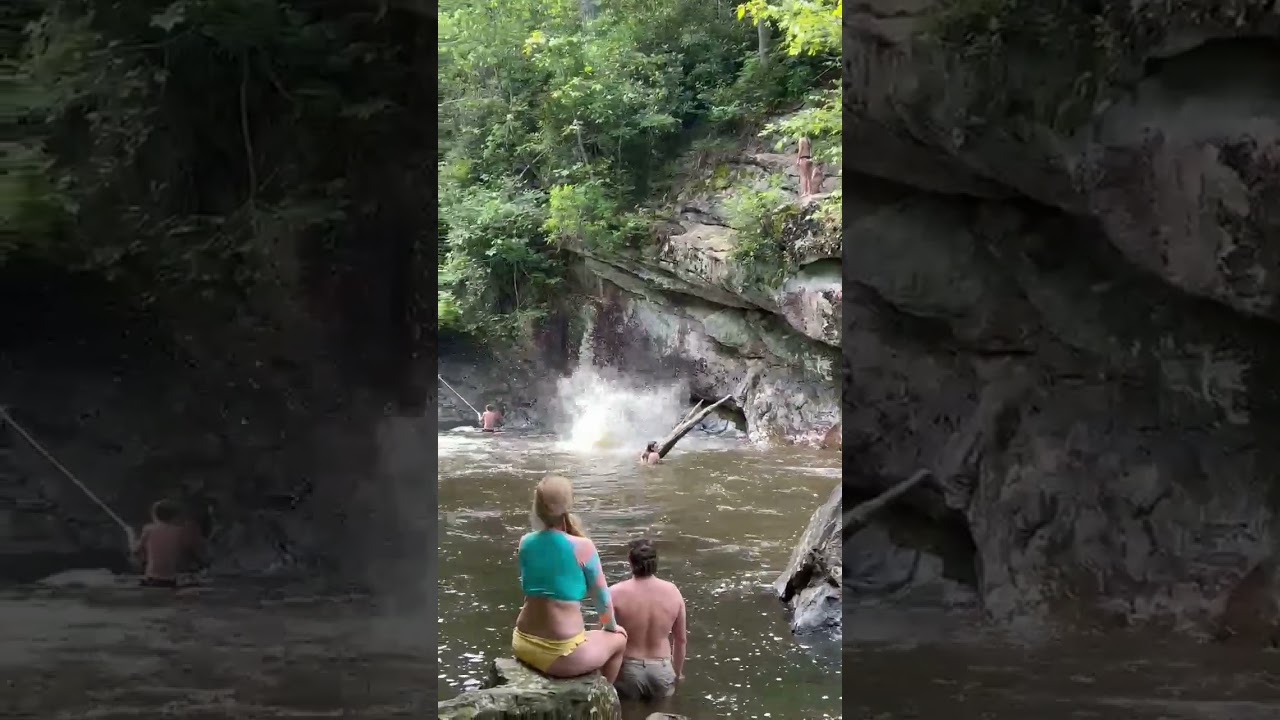 Jumping off rocks at Bust Your Butt Falls in NC.