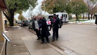 Pallbearers carry casket