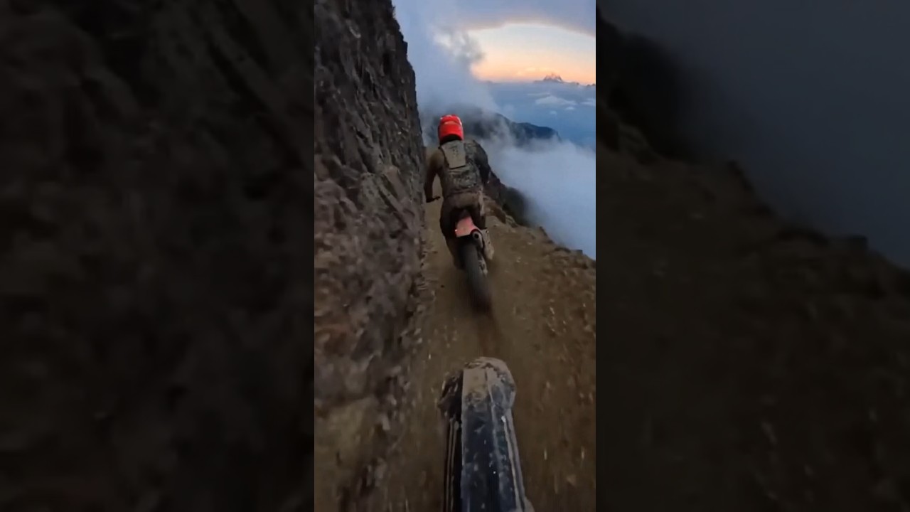 POV Extreme Mountain Biking on a Dangerous Cliffside Trail Above the Clouds 