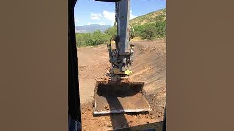 Cutting a 2:1 Slope with a Engcon Tilt Rotator on a John Deere 250G with a 78” Grading Bucket.