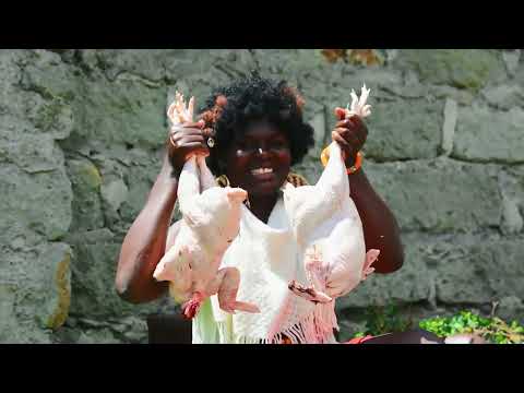 African village girl slaughtering two Big native chicken and cooking them outside