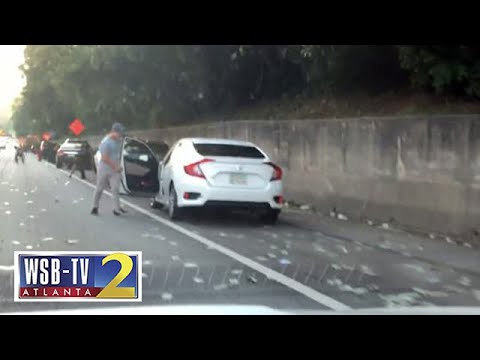 CASH GRAB: Drivers stop on I-285 to collect cash that fell from armored truck