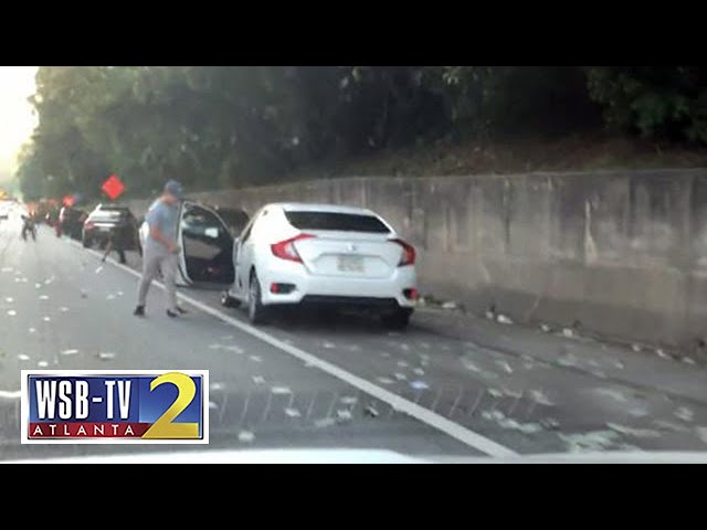 Drivers stop on I-285 to collect cash that fell out of armored truck Video Thumbnail