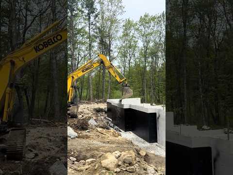 Finishing up the foundation drain with stone before backfilling ￼