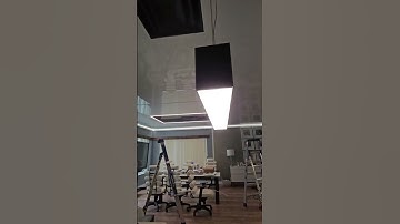 glossy stretch ceiling and light lines in an office space