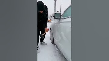 Scraping ice from the car