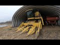 Dumping Corn into a Giant Wagon from a  New Holland TR86 Combine