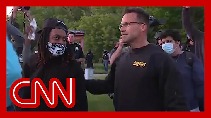 Sheriff drops riot gear and joins peaceful protest...