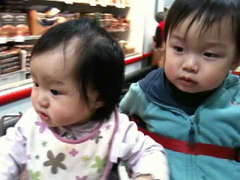 Audrey and Elliott taking a ride in Costco