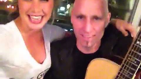 Matt Scannell plays guitar as Kristin Vahl sings (or tries
