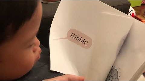 3 years old boy with Down syndrome is reading