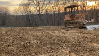 Clearing trees and filling in old pond with case 450B dozer on the farm
