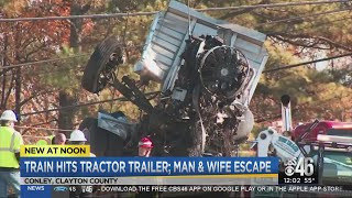 Train hits tractor trailer; man and wife escape