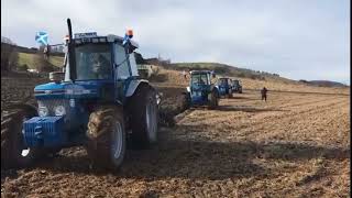 5 Synchronized Tractors Engaged in Plowing Simultaneously