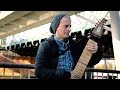 Playing chapman stick musical instrument street performer live guitar music