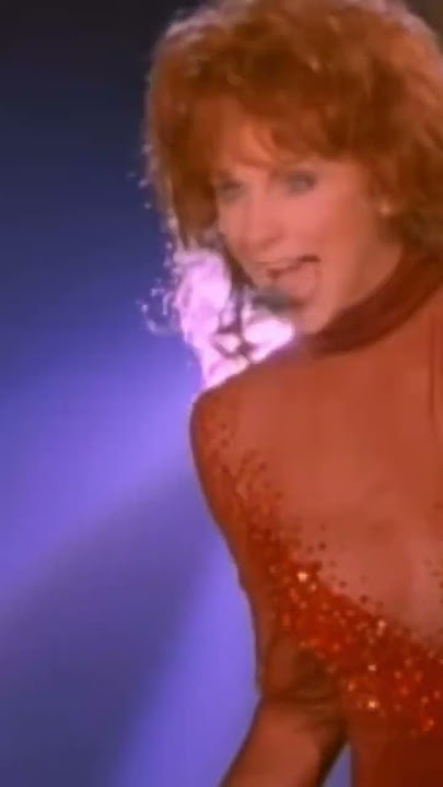 Reba performing Fancy in her ‘controversial’ red dress (1994).