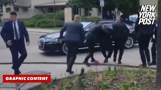 Slovakian Prime Minister Robert Fico is rushed to car after being shot