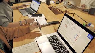 People working with Macbook on a wooden table | Free stock Apple video People working with Macbook on a wooden table | Free stock Apple video