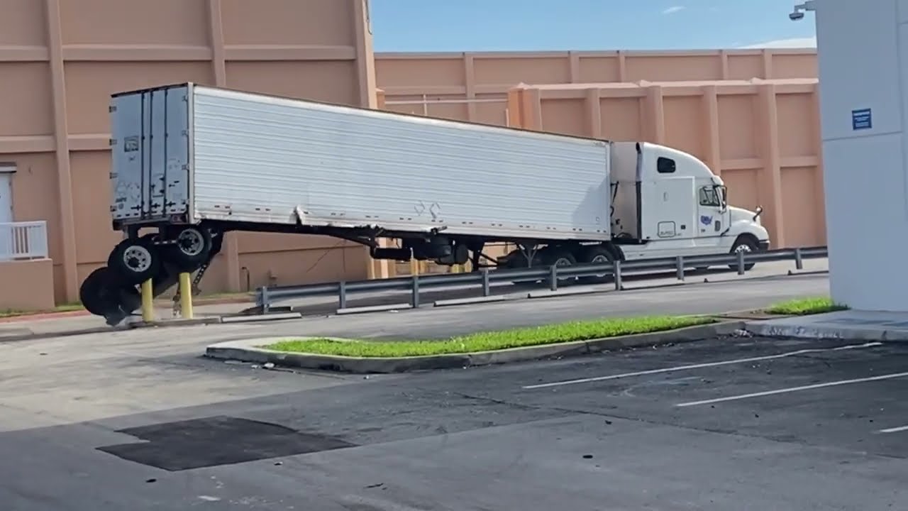 Semi Truck Loses Back Wheels Trying to Turn Around Safety Barriers