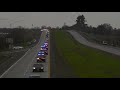 See Natalie Corona procession stretch and flash far down Highway 113