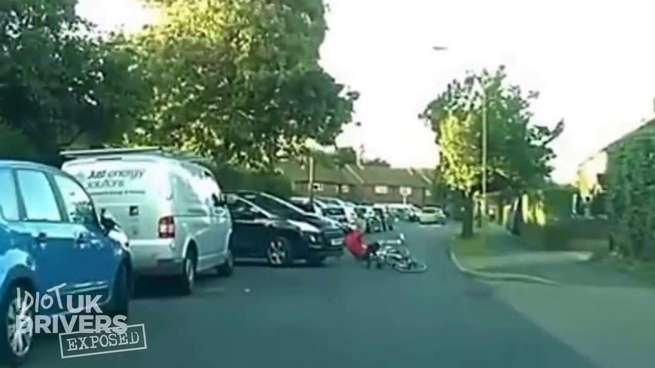Cyclist using his mobile gets knocked off his bike by a car edging out ...