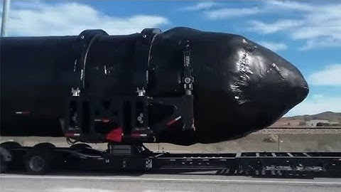 MASSIVE black clad cigar-shaped object filmed near Area 51 on truck