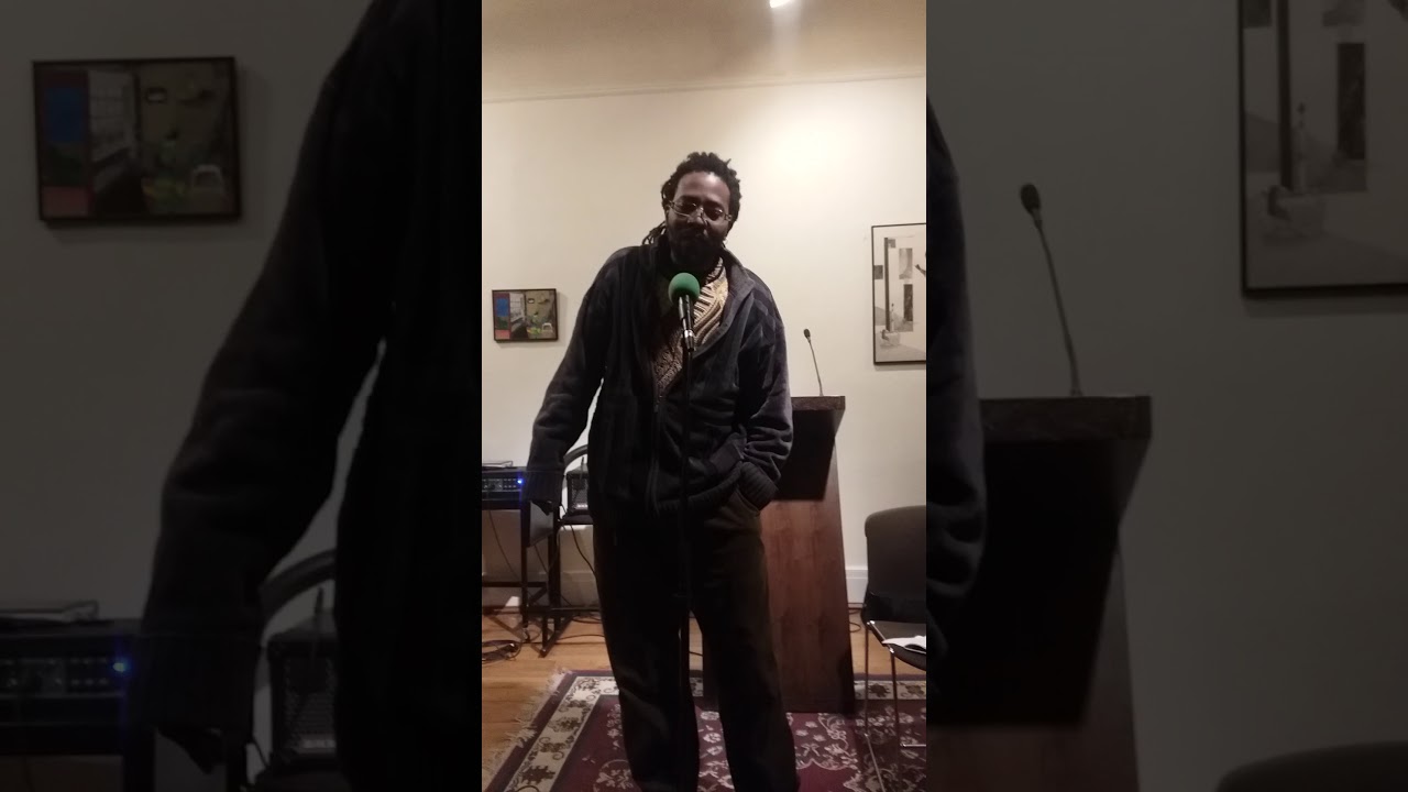 Brownskin . Dreads hang .