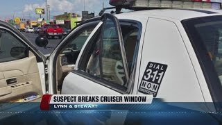 Man tries to escape arrest, kicks police car window out
