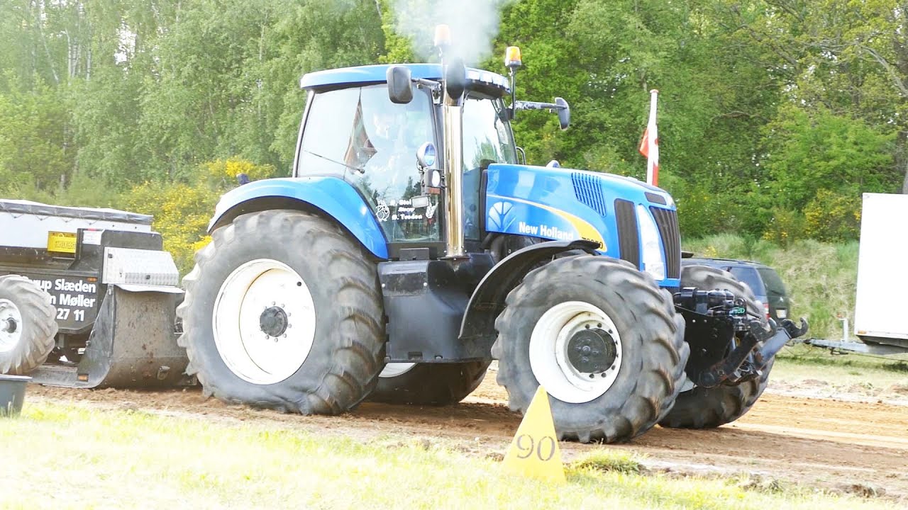 Different New Holland Tractors in front of the sledge doing some Tractor Pulling