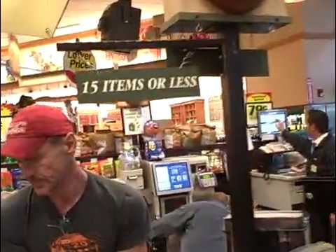 Weird Al Yankovic repairs a sign in a grocery store