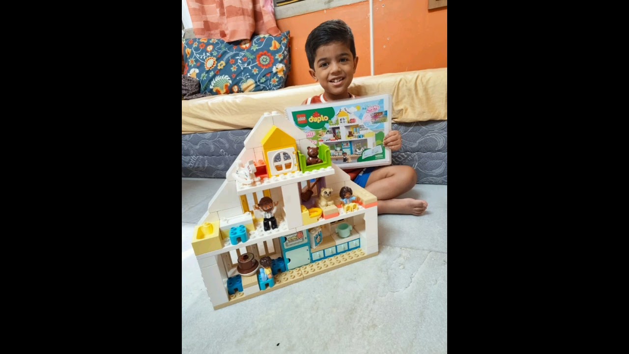 Kid making Lego house from Unnati library