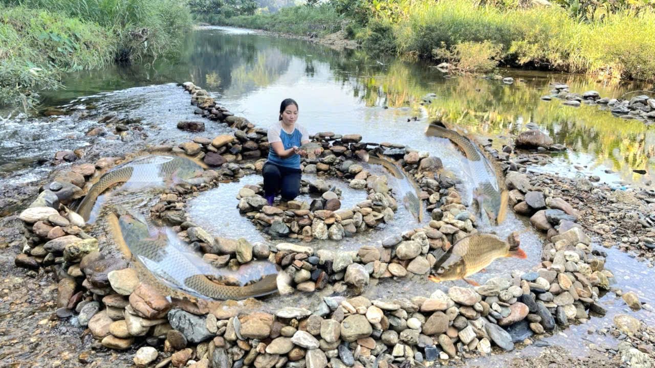 The girl created a fish trap with stones arranged in a spiral shape ...