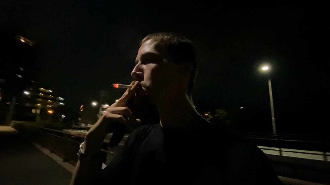Smoking a Cigarette on a Bridge Over a River in Hiroshima