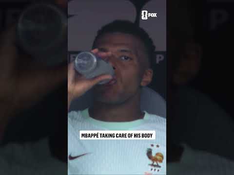 Mbappé icing his right ankle on the bench