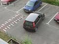 Woman trying to reverse out of parking space.