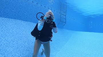 Scuba student removing and replacing her BC underwater