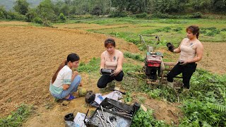 The mechanic girl repairs a tractor that has not been used for a long time