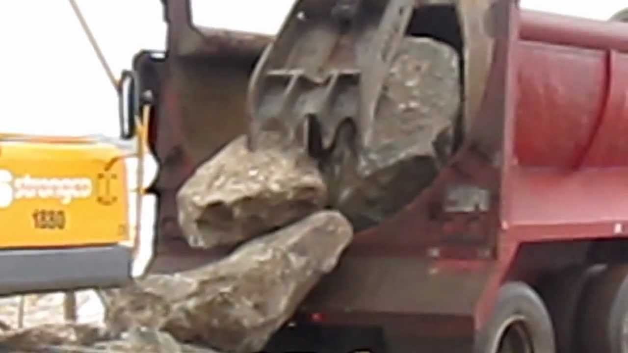 Unloading rock for shore protection - YouTube
