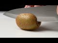 Delicate ASMR Macro: Precision Slicing a Fresh Kiwi Shot: Hyperrealistic macro, capturing the ...