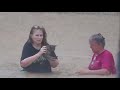 Residents wade through floodwaters to rescue a stranded kitten in Mississippi