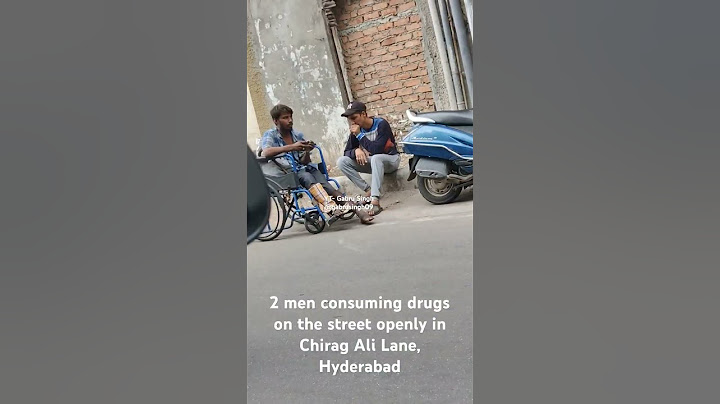 2 men consuming drugs openly on the road, They poured liquid on the cloth and started to smell it