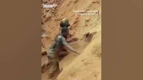 A man dodges falling rocks and uses his bare hands to pull trapped gold miners